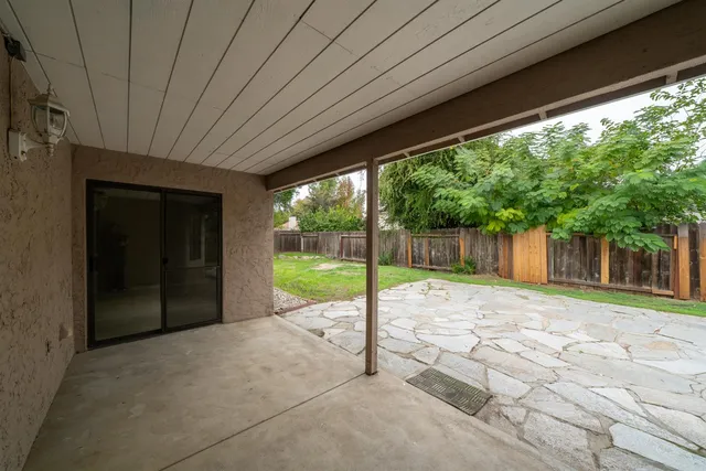 a view of a house with backyard and porch
