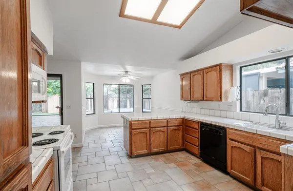 a large kitchen with a sink and cabinets