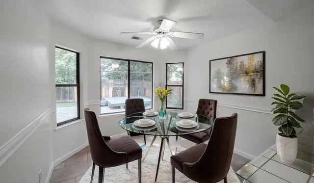 a dining room with furniture and window