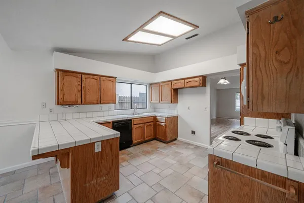 a kitchen that has a sink and a stove