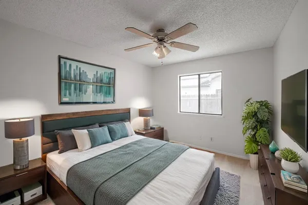 a bedroom with a bed and a window