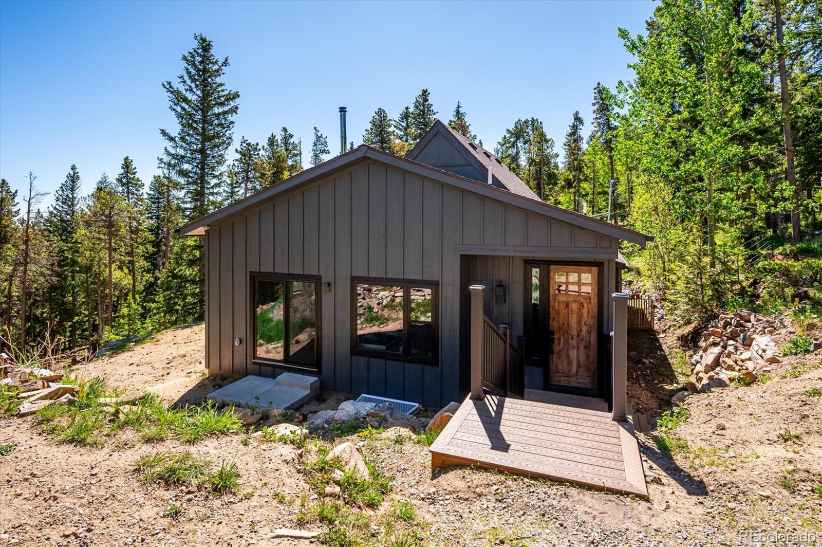 1633 Sinton Road Evergreen, CO 80439 - Photo 10 of 50 a backyard of a house with table and chairs