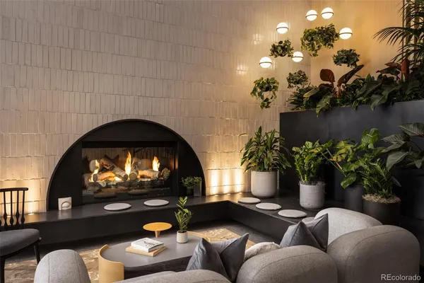 a living room with furniture flowers and a fireplace