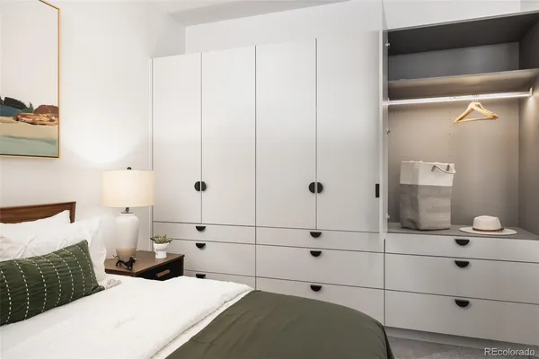 a bedroom with a bed and a mirror