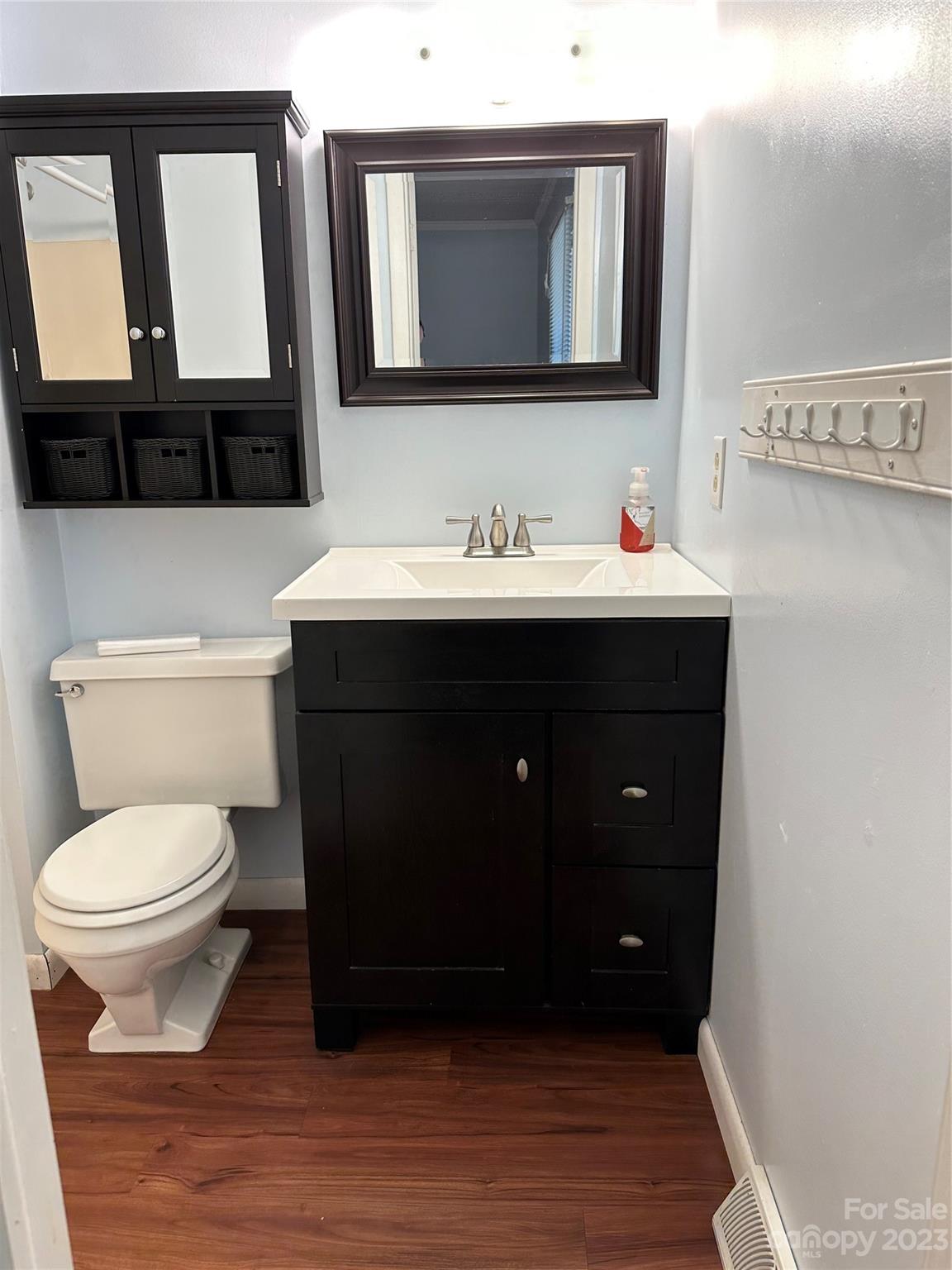 140 Hillside Drive Salisbury, NC 28147 - Photo 22 of 29 a bathroom with a toilet a sink a mirror and a window
