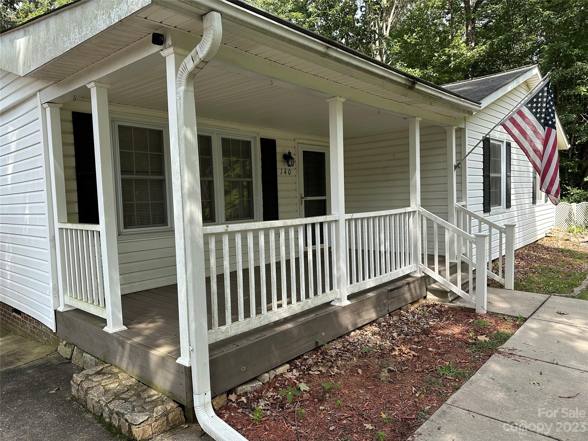 140 Hillside Drive Salisbury, NC 28147 - Photo 4 of 29 a porch with a bench next to a yard