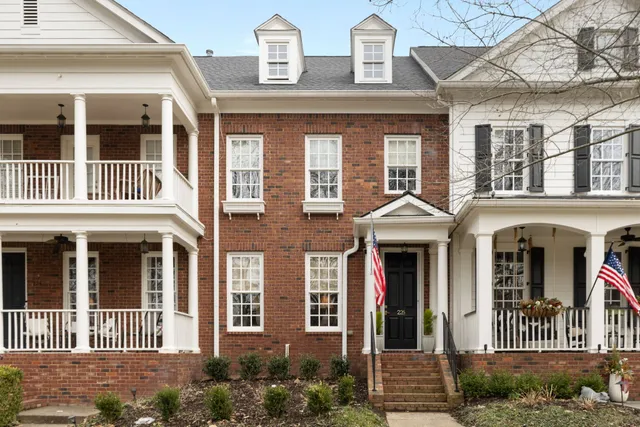 a front view of a residential apartment building with a yard