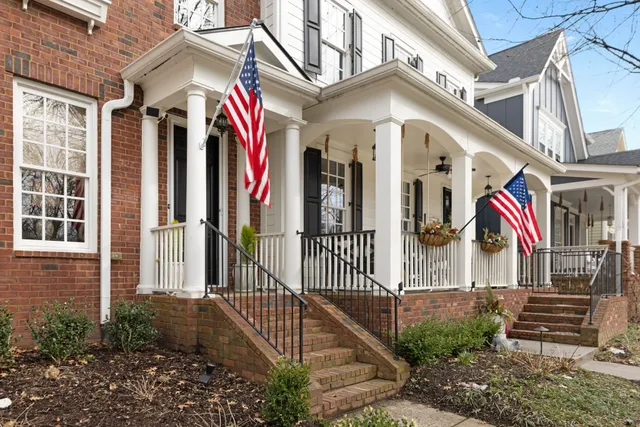 a living room with furniture a rug and a chandelier