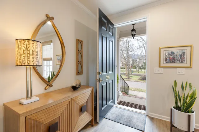 a kitchen with stainless steel appliances granite countertop a refrigerator a sink dishwasher a stove and white cabinets with wooden floor