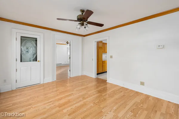 a big room with wooden floor and closet area