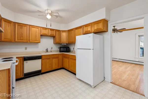 a kitchen with sink cabinets and refrigerator
