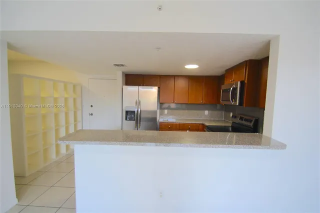 a view of kitchen with refrigerator and window