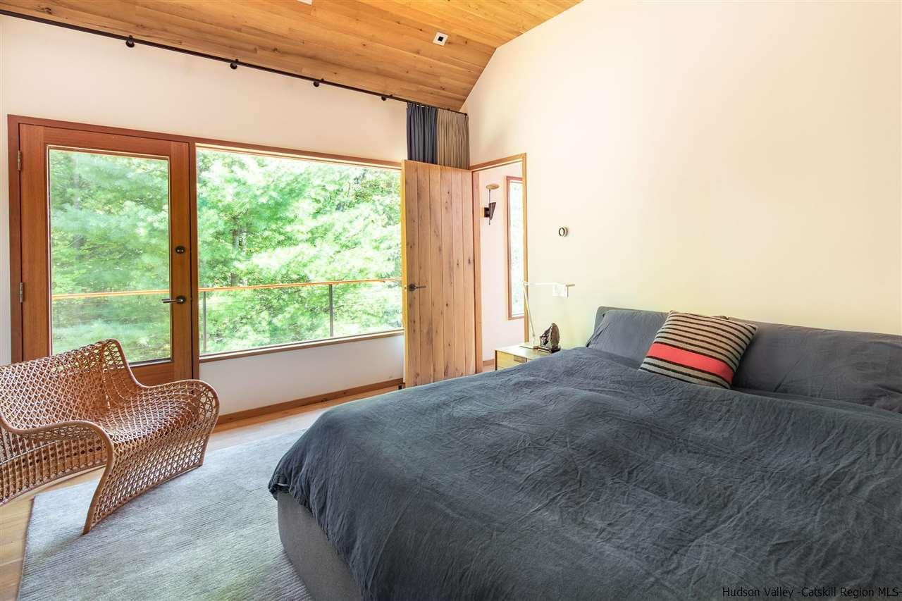 60 Ridgewood Road Kerhonkson, NY 12446 - Photo 12 of 31 a bedroom with a bed and glass window