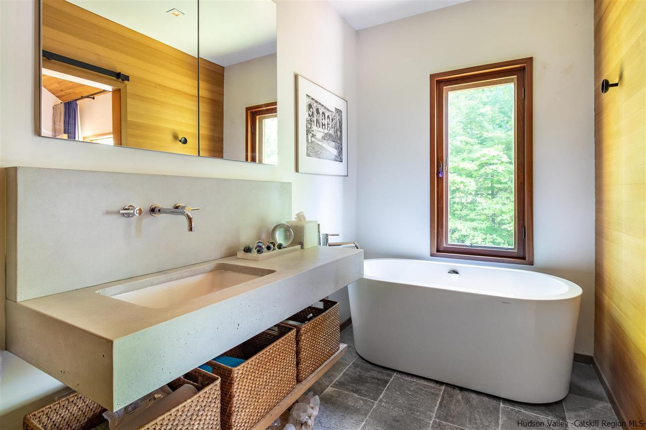 60 Ridgewood Road Kerhonkson, NY 12446 - Photo 13 of 31 a bathroom with a tub a sink and a window