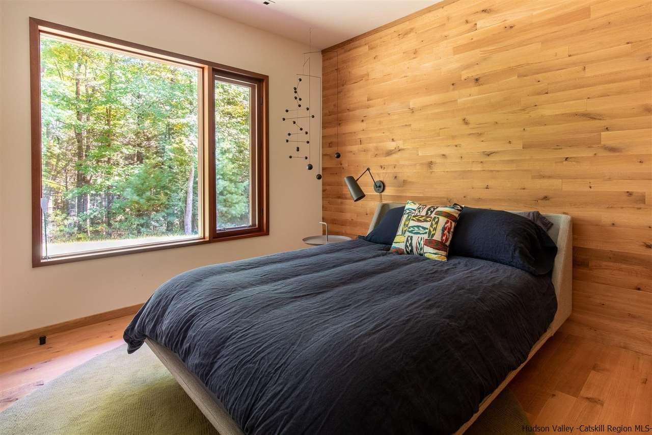 60 Ridgewood Road Kerhonkson, NY 12446 - Photo 19 of 31 a bed sitting in a bedroom next to a window