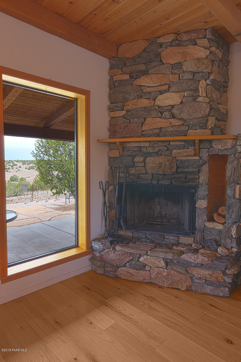 7600 Dillon Wash Road Prescott, AZ 86305 - Photo 8 of 35 a view of empty room with wooden floor and fireplace