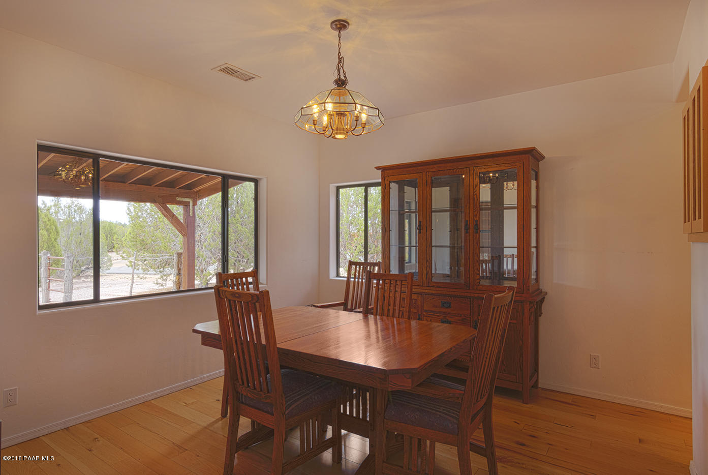 7600 Dillon Wash Road Prescott, AZ 86305 - Photo 10 of 35 a dining room with furniture a chandelier and wooden floor