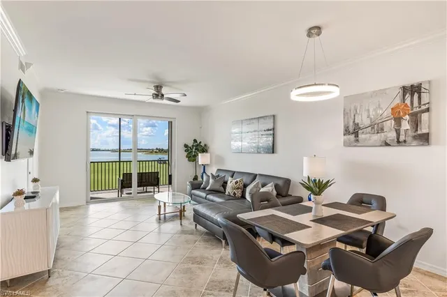 a living room with furniture and a floor to ceiling window