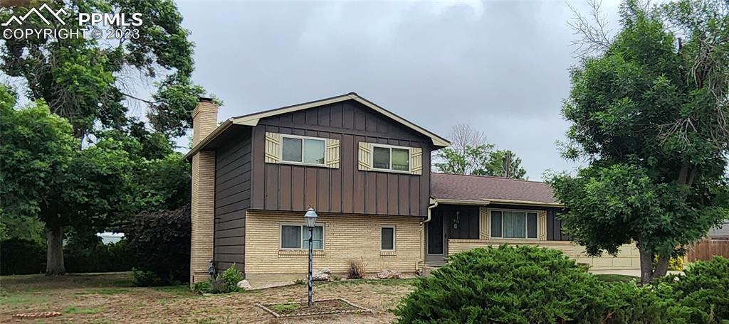 1404 Imperial Road Colorado Springs, CO 80918 - Photo 1 of 26 a front view of a house with a garden