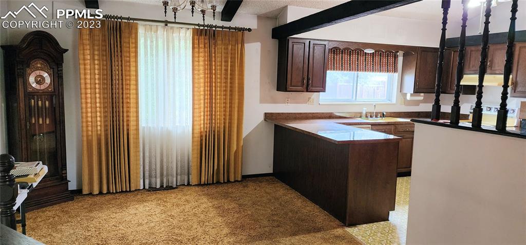 1404 Imperial Road Colorado Springs, CO 80918 - Photo 11 of 26 a kitchen with a sink and a refrigerator