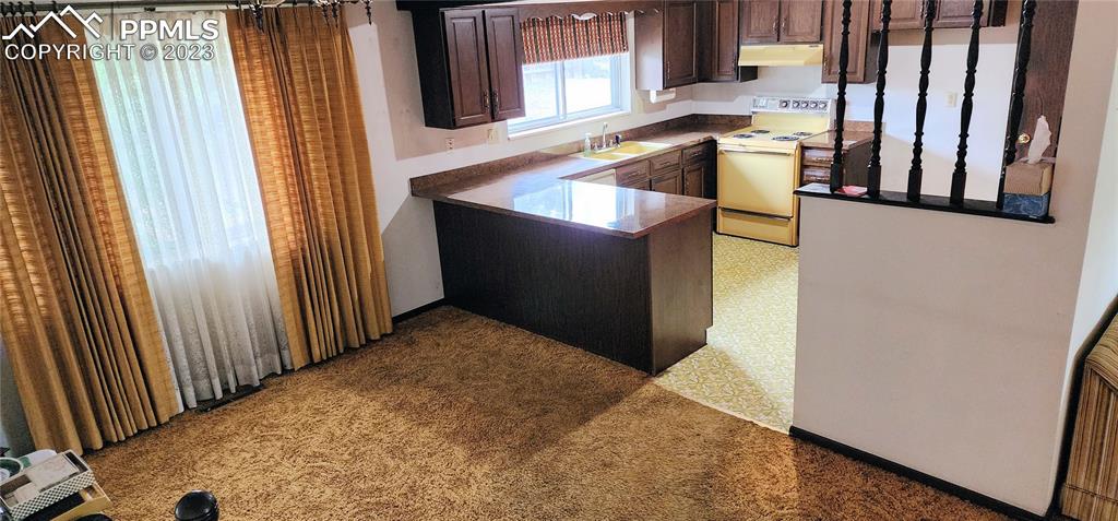 1404 Imperial Road Colorado Springs, CO 80918 - Photo 12 of 26 a kitchen with a sink and a refrigerator