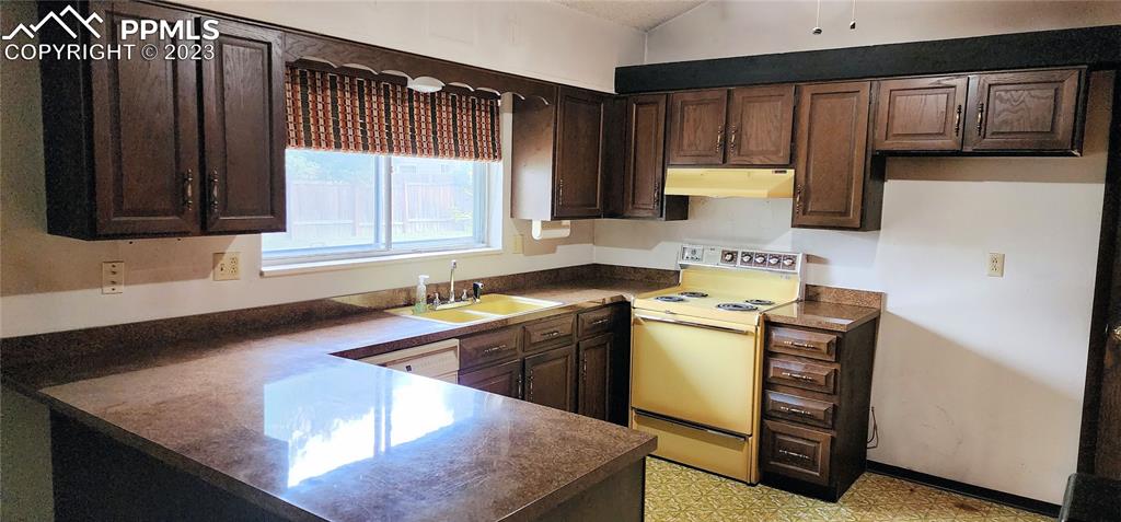 1404 Imperial Road Colorado Springs, CO 80918 - Photo 14 of 26 a kitchen with stainless steel appliances granite countertop a sink stove and cabinets