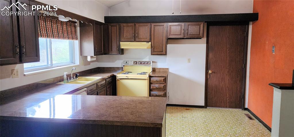 1404 Imperial Road Colorado Springs, CO 80918 - Photo 15 of 26 a kitchen with sink cabinets and window
