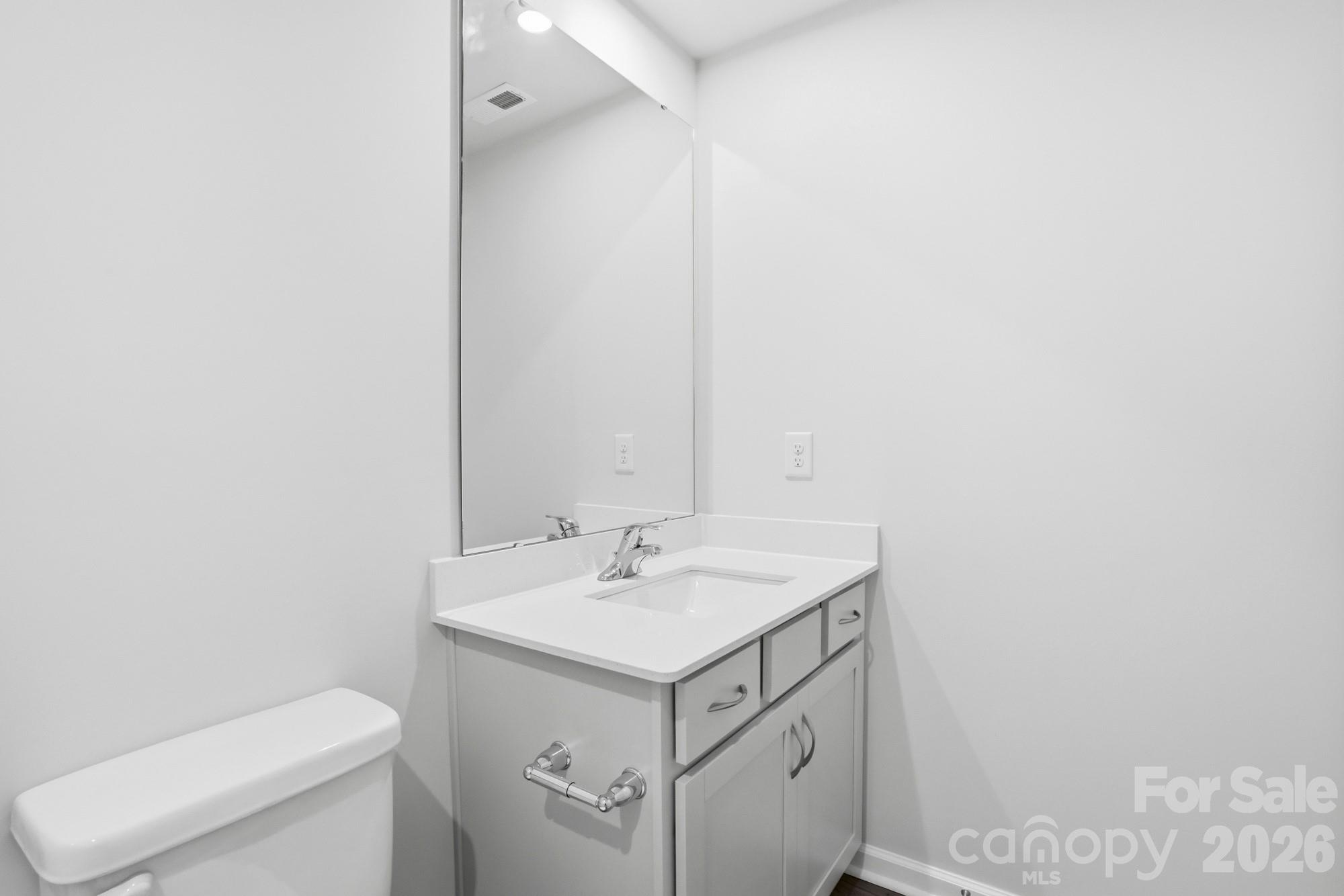 2540 Hedgecliff Road Kannapolis, NC 28083 - Photo 21 of 22 a bathroom with a sink toilet and mirror