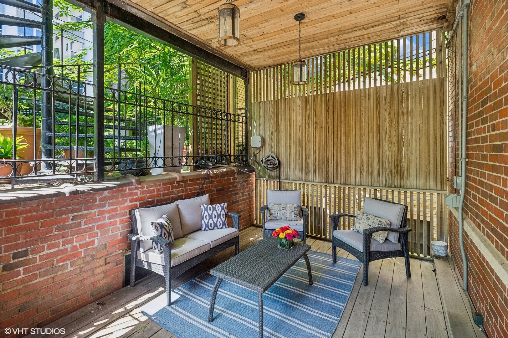 655 West Junior Terrace, Unit 1 Chicago, IL 60613 - Photo 21 of 24 a balcony with furniture and wooden floor