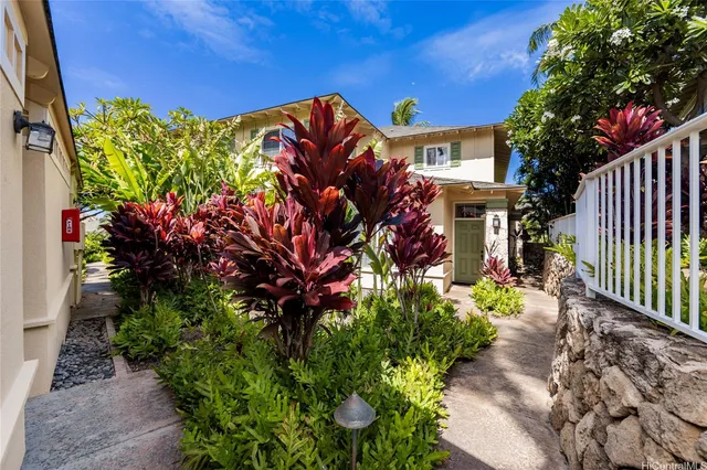 a view of a house with a flower garden