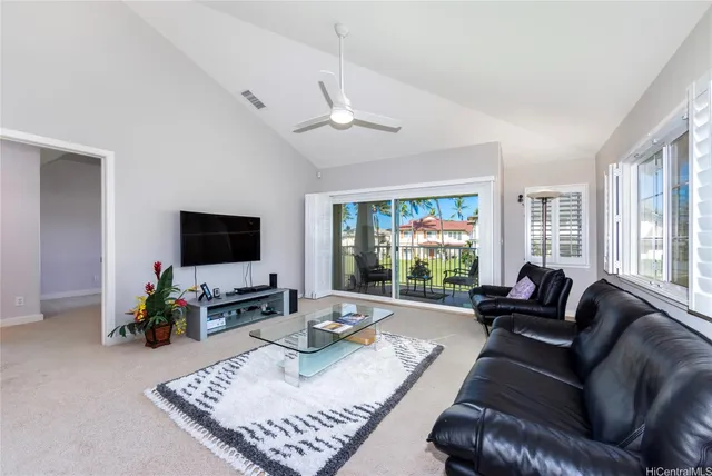 a living room with furniture a flat screen tv and a large window