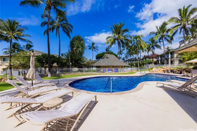 a swimming pool with outdoor seating and yard