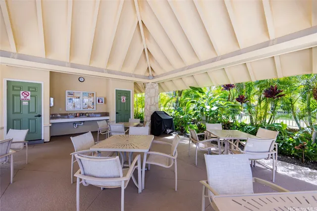 a dining room with furniture a rug and entryway
