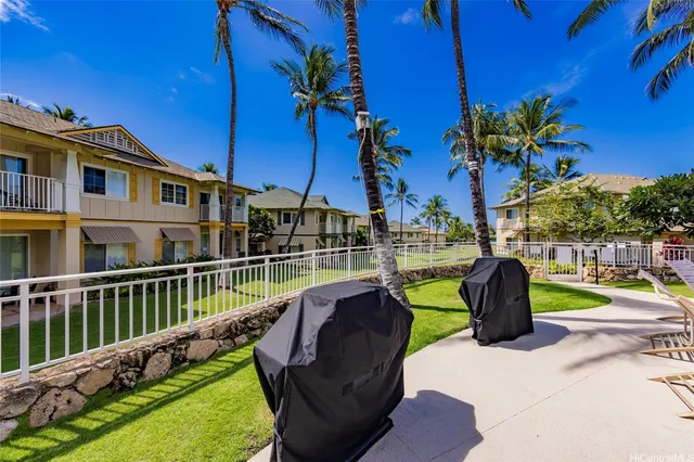 a view of a swimming pool with a patio and a garden