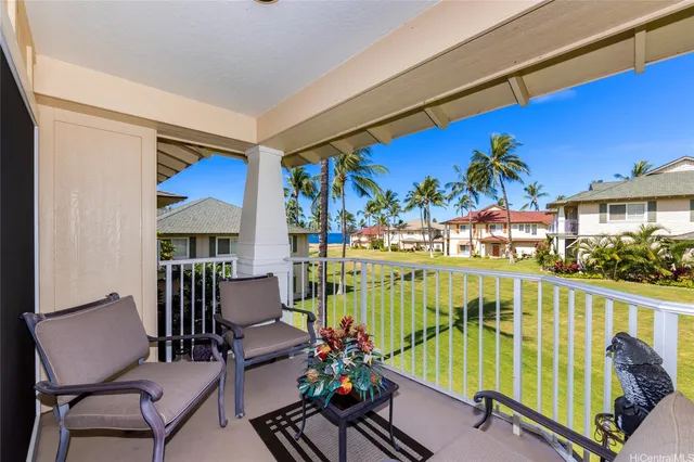 a view of a chairs and table in the balcony