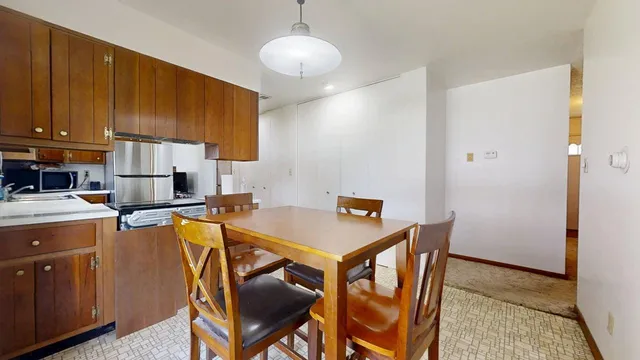 a kitchen with a stove a refrigerator and cabinets