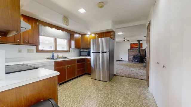 a kitchen with refrigerator and window