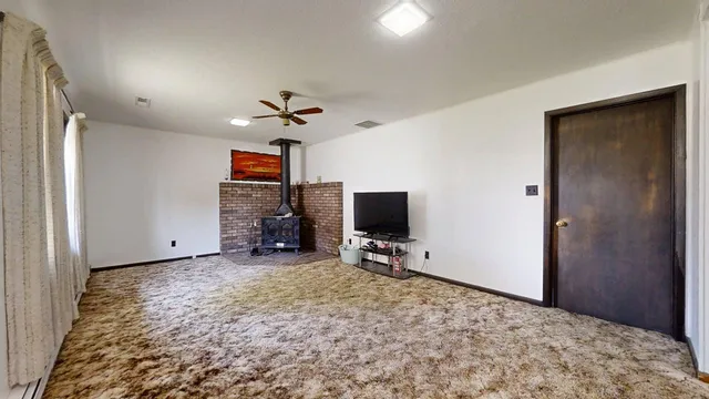 a view of a livingroom with a flat screen tv and a fireplace