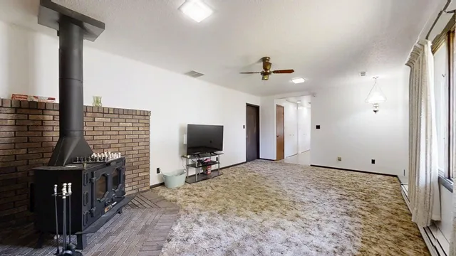 a view of livingroom with flat screen tv and windows