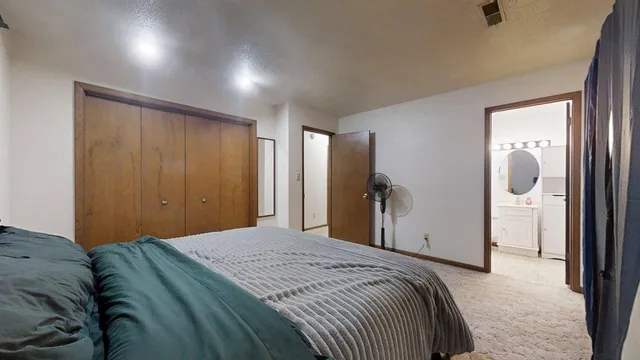 a bedroom with a bed and a mirror