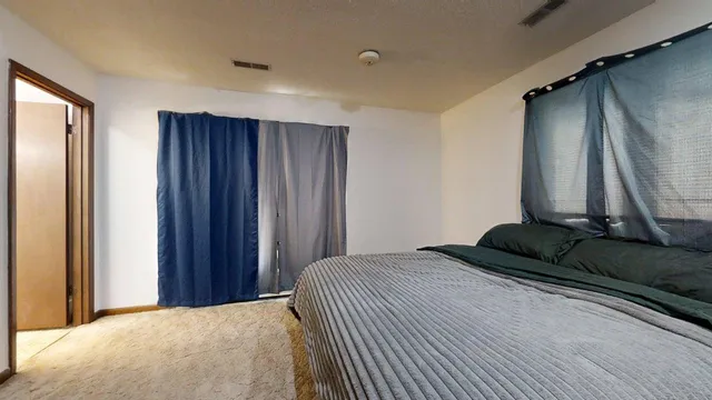 a bedroom with a bed and a dresser