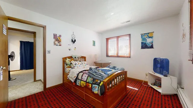 a bedroom with furniture and a wooden floor