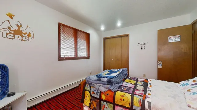 a bedroom with furniture and a window