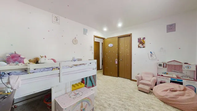 a bedroom with a bed and a couch