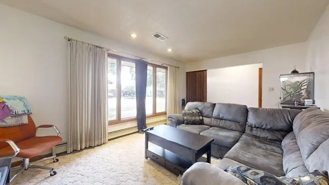 a living room with furniture and a large window