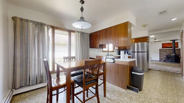 a dining room with furniture and a chandelier