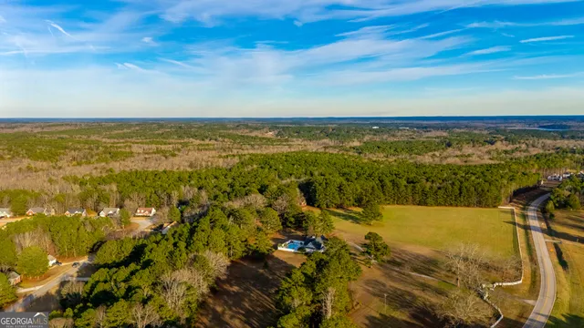 an aerial view of a houses with a yard