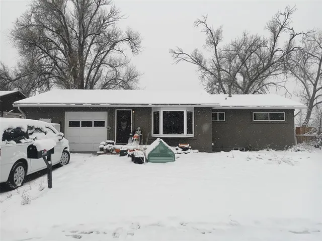 a view of a house with a yard covered in snow