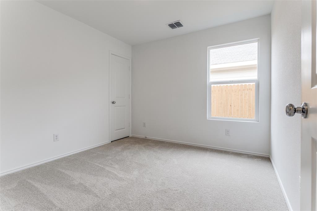 127 Sunflower Street Princeton, TX 75407 - Photo 11 of 21 Empty room featuring a healthy amount of sunlight and carpet flooring
