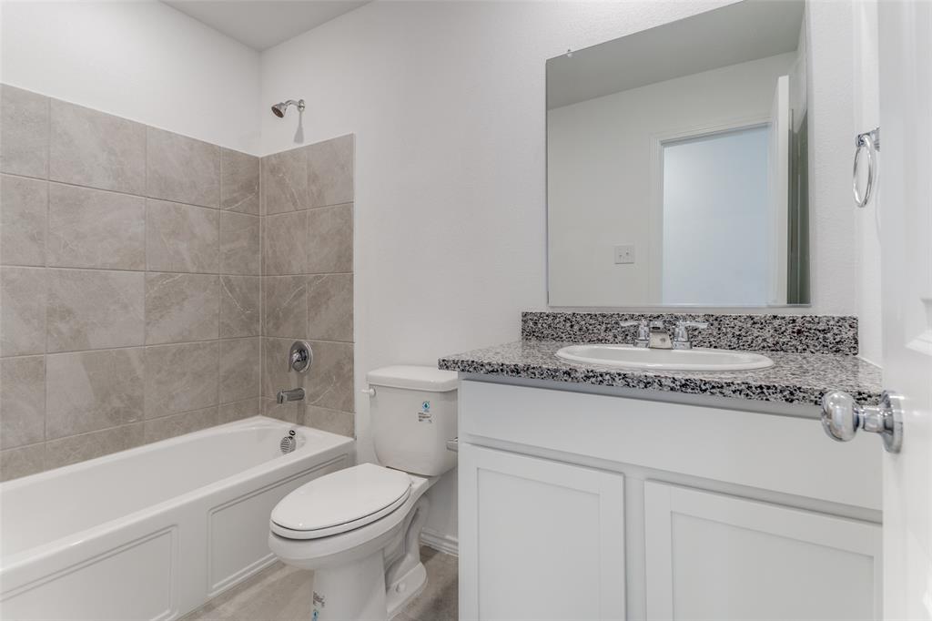 127 Sunflower Street Princeton, TX 75407 - Photo 12 of 21 Full bathroom with tiled shower / bath combo, toilet, and large vanity